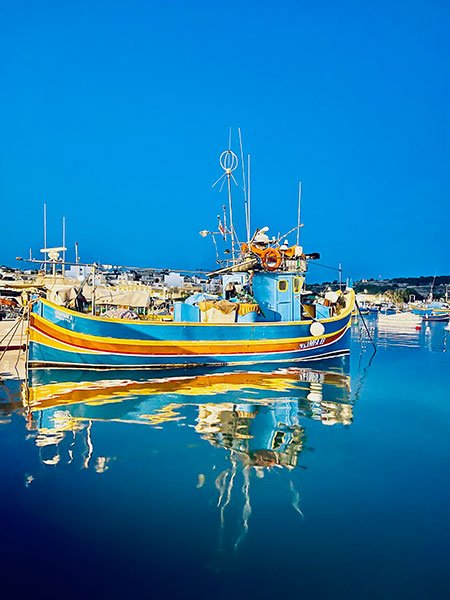 An iconic landmark of Gozo and Malta is the Luzzu, the typical fishing boat on both islands to this day.